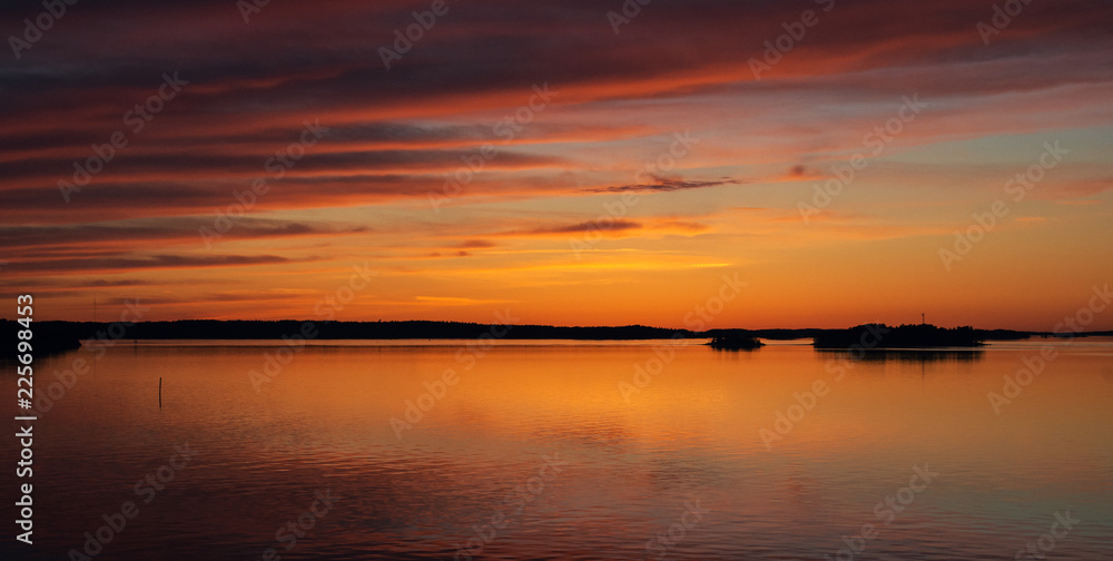 A natural Dramatic, blazing sunset in the Baltic sea. Bright sky and clouds. beautiful seascape as background A natural Dramatic, blazing sunset in the Baltic sea. Bright sky and clouds. beautiful seascape as background