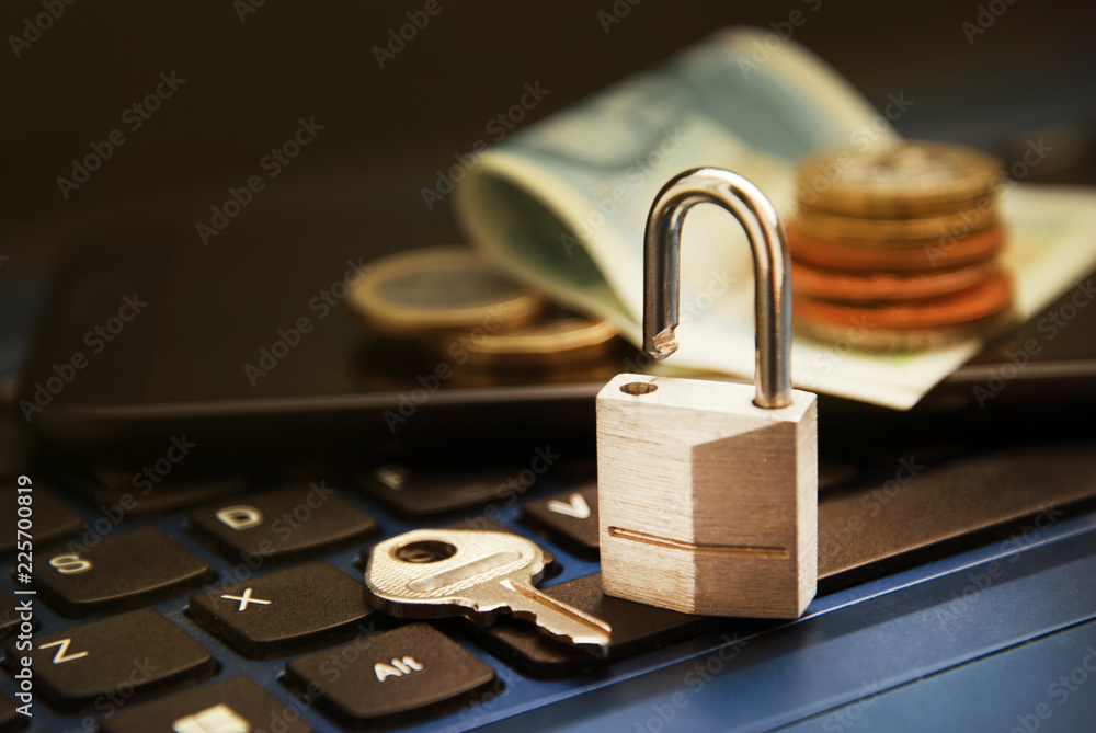Online shopping concept. Padlock on laptop beside money on laptop. Non secure online shopping concept. Online shopping concept. Padlock on laptop beside money on laptop. Non secure online shopping concept.