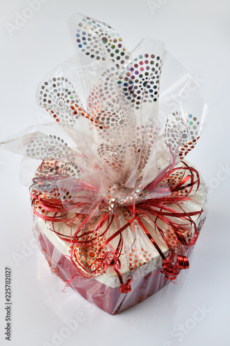 Fotografi box with gift packed in cellophane on light background