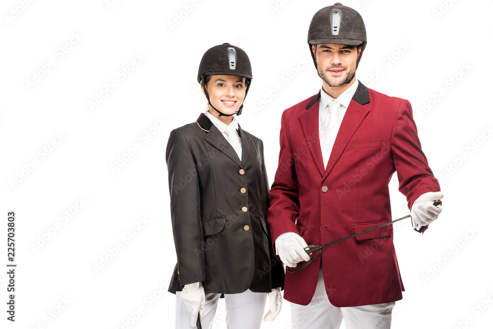 attractive young equestrians in uniform and helmets looking at camera isolated on white attractive young equestrians in uniform and helmets looking at camera isolated on white