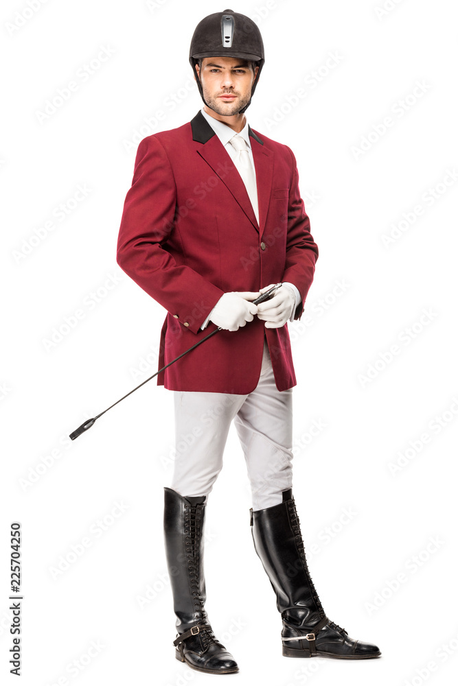 handsome young horseman in uniform holding horseman stick and looking at camera isolated on white handsome young horseman in uniform holding horseman stick and looking at camera isolated on white