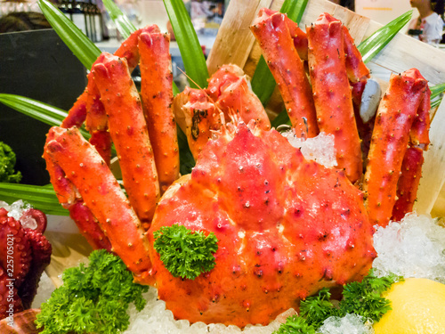 Fresh, juicy and tasty poached whole Alaskan king crab or Taraba crab in their shell on ice bed. Sweet and flavorful. Contain cholesterol, but low in saturated fat and also have omega-3 fatty acid.
