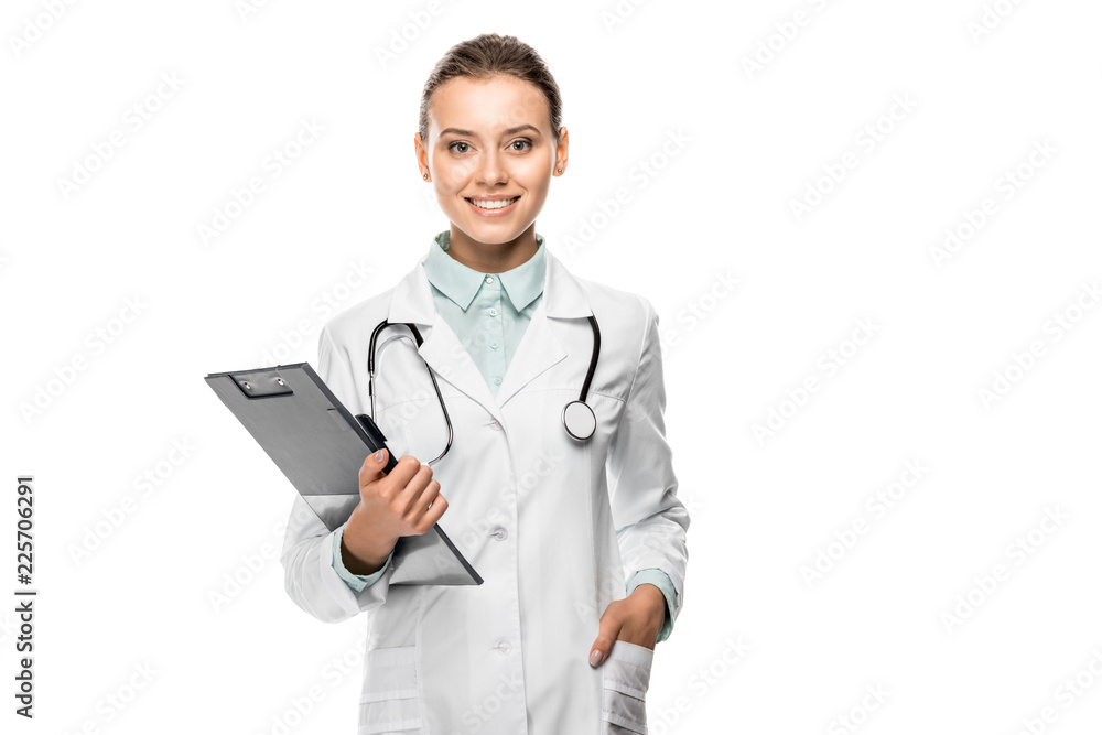 cheerful young female doctor in medical coat holding clipboard isolated on white cheerful young female doctor in medical coat holding clipboard isolated on white