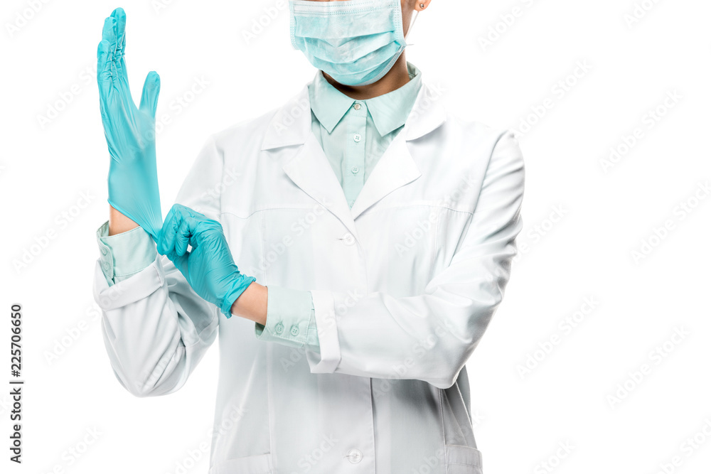 cropped image of female doctor in medical mask putting on latex gloves isolated on white cropped image of female doctor in medical mask putting on latex gloves isolated on white