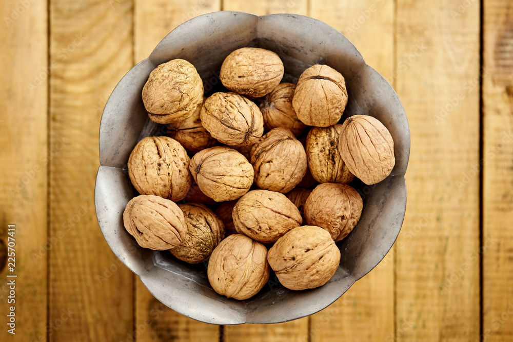 bowl full of delicious and fresh walnuts on an old wooden table bowl full of delicious and fresh walnuts on an old wooden table