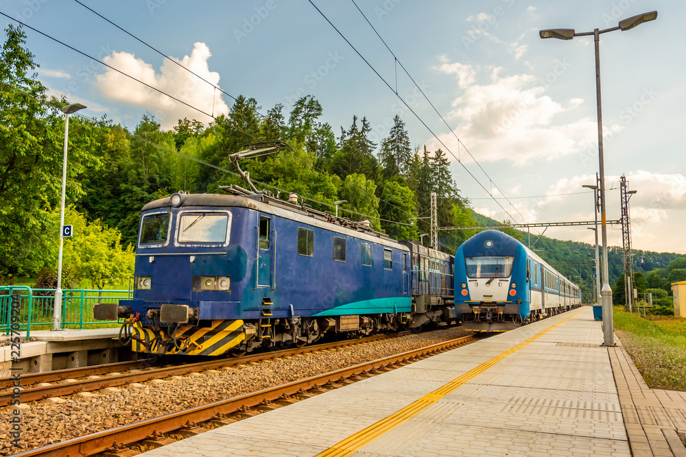 Two blue trains at the station. Rail transport in the Czech Republic. A sunny day on the railroad Two blue trains at the station. Rail transport in the Czech Republic. A sunny day on the railroad