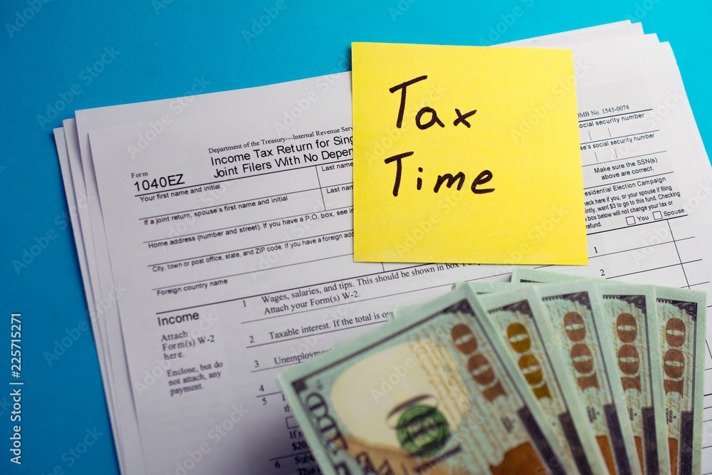 Obraz premium Individual income tax return 1040 ez tax form with money on table. Lodging your tax return