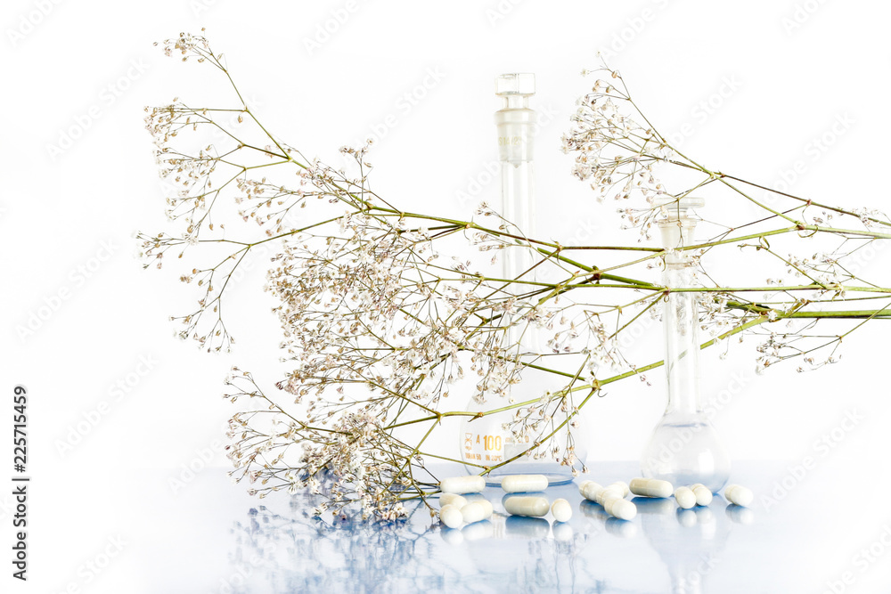 White pills with herbs and vials White pills with herbs and vials