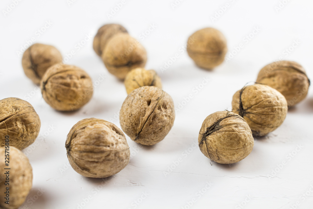 Walnuts on white textured surface. Close up. Walnuts on white textured surface. Close up.