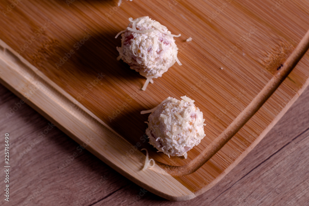 Tasty cheese balls served in the wooden plate Tasty cheese balls served in the wooden plate