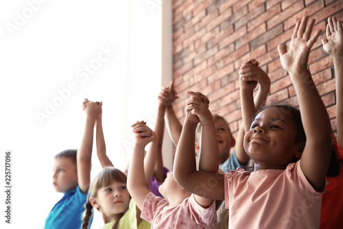 Little children holding hands together indoors. Unity concept