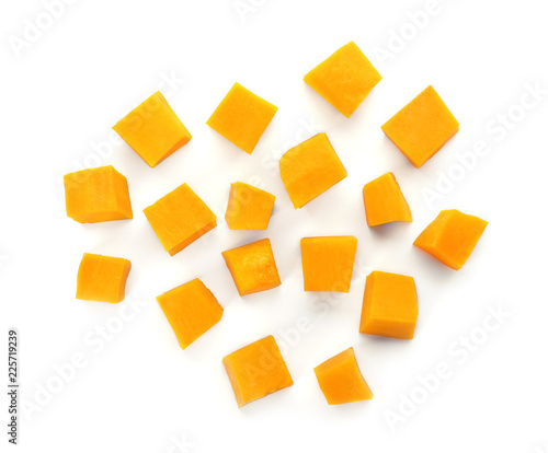 Fresh raw pumpkin pieces isolated on white, top view