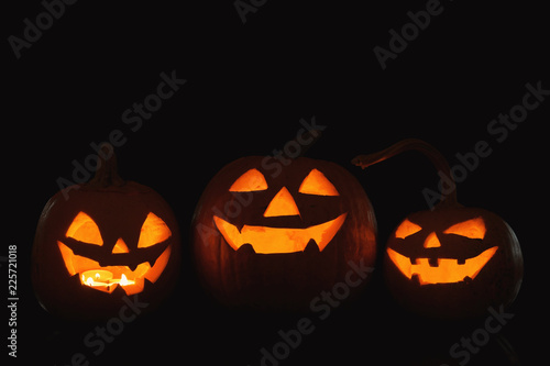 Halloween pumpkin heads. Glowing jack lanterns in dark © New Africa