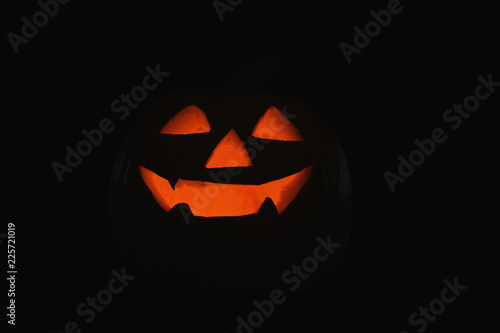 Halloween pumpkin head. Glowing jack lantern in dark © New Africa