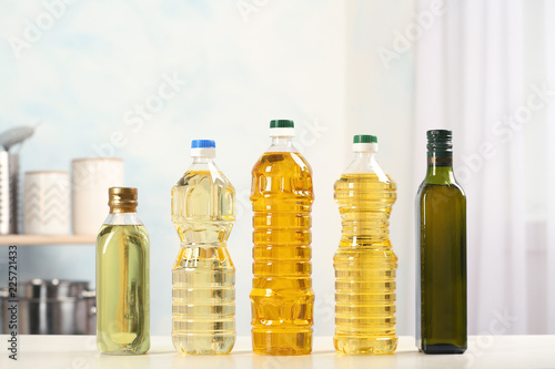 Bottles of oils on table against blurred background