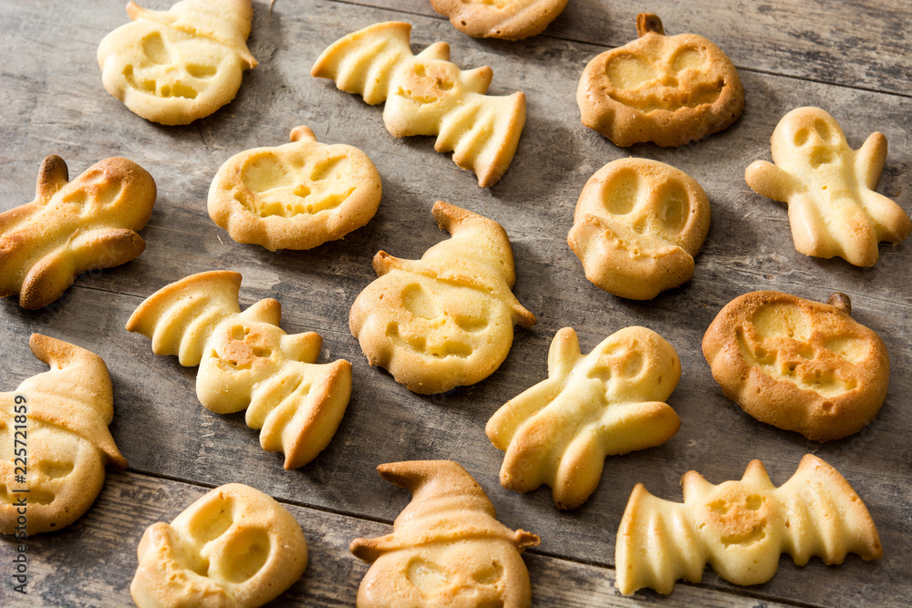 Homemade Halloween cookies on wooden table background. 