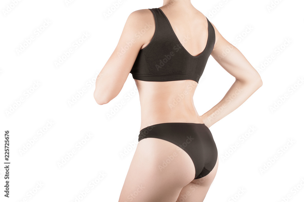 Female cropped fit back and buttocks in black panties and top, isolated on white. Female cropped fit back and buttocks in black panties and top, isolated on white.