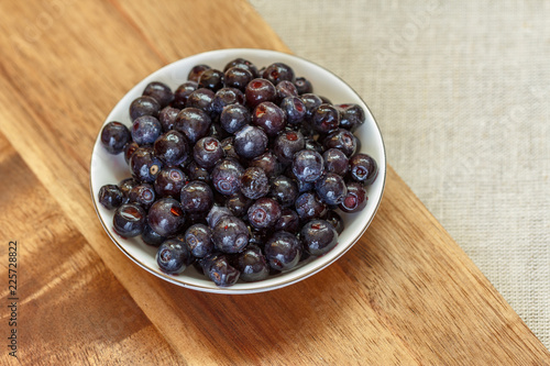 Frozen forest blueberries thawed in a small saucer