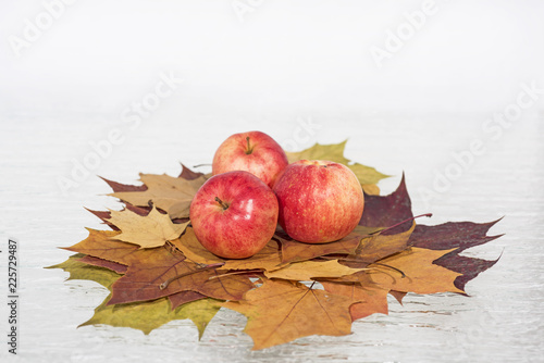 Red lantern lamp with candle and apples on red background photo