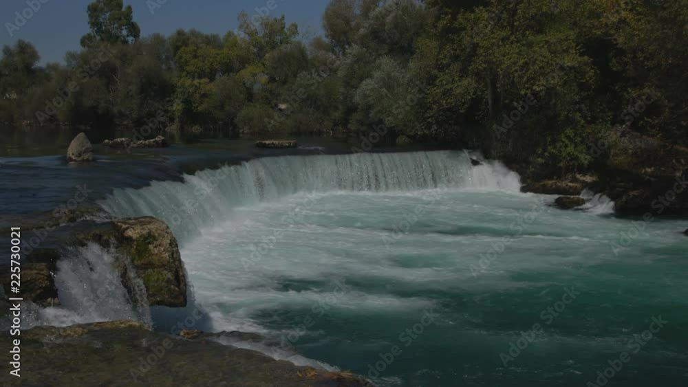 Stormy waterfall on a calm river. Stormy waterfall on a calm river.
