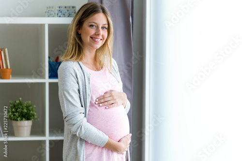 Beautiful pregnant woman relaxing at home Free Download Beautiful pregnant woman relaxing at home - GFXLoad