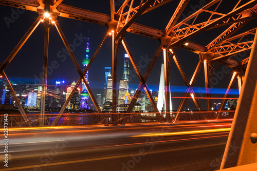 Shanghai, China - December 25 2017: Shanghai Skyline at night - long exposure - bridge looking at tv oriental building
