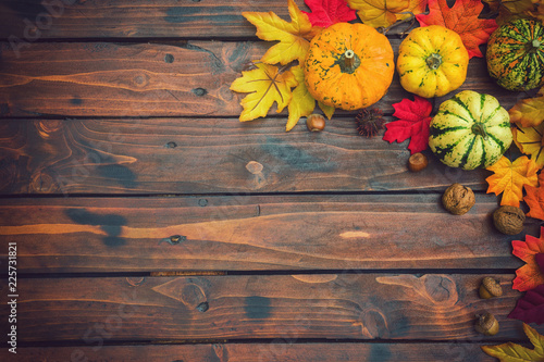 Autumn background with colorful leaves and pumpkins