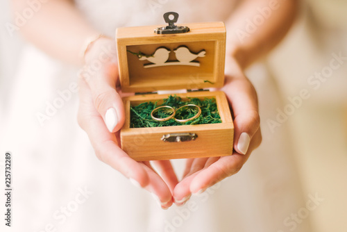 hand holding wedding box with ring
