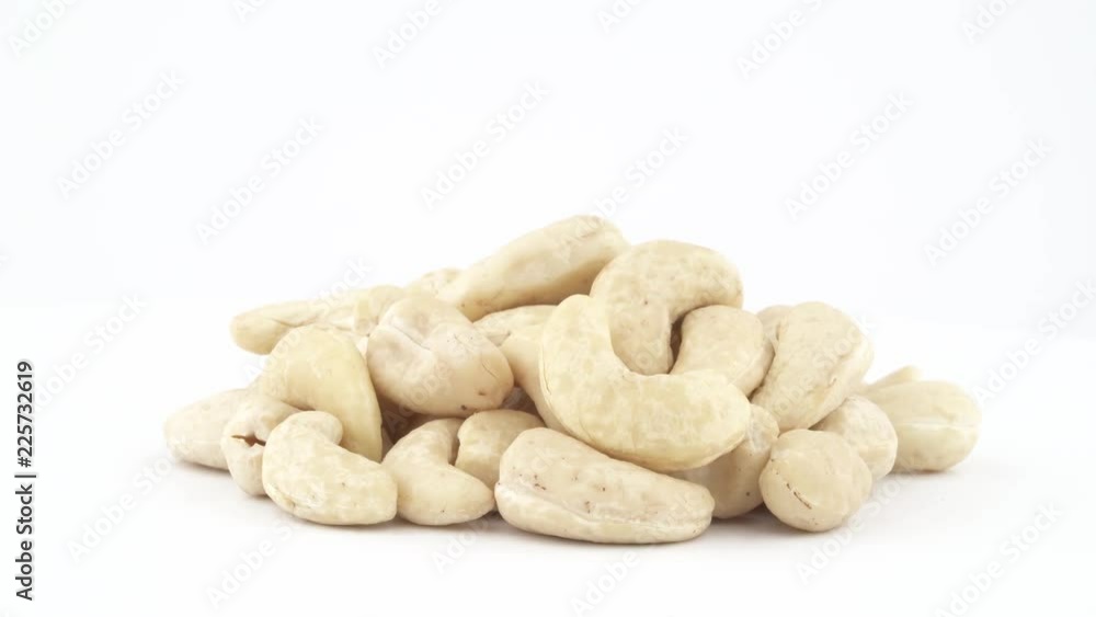 Heap of cashew nuts. Rotating on the turntable isolated on the white background. Close up. Macro. Heap of cashew nuts. Rotating on the turntable isolated on the white background. Close up. Macro.