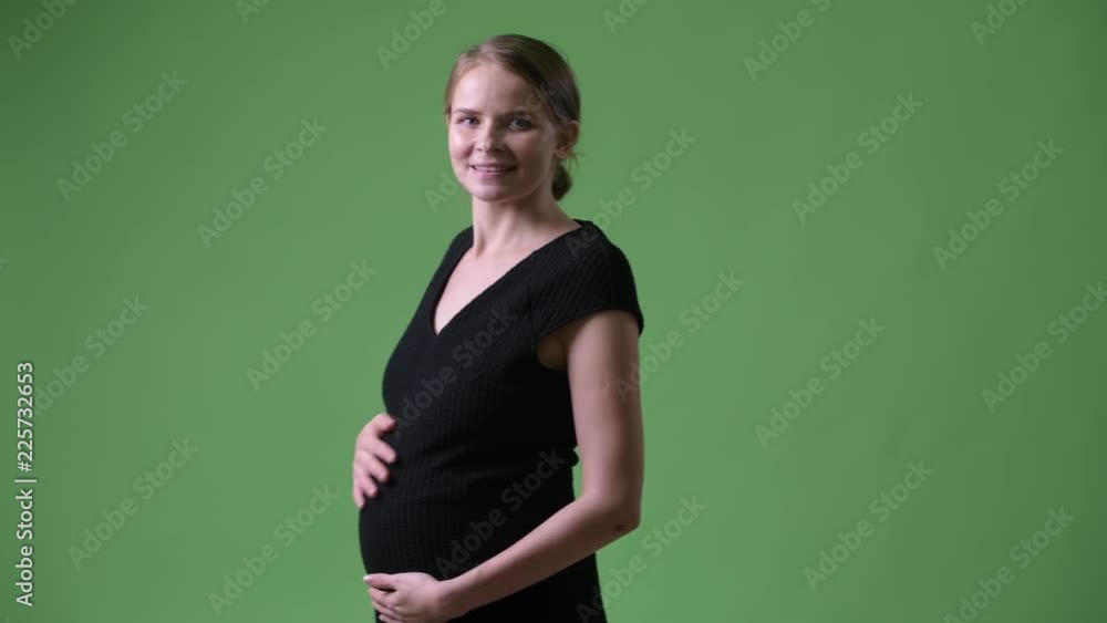 Rear view of young beautiful pregnant businesswoman looking back Rear view of young beautiful pregnant businesswoman looking back