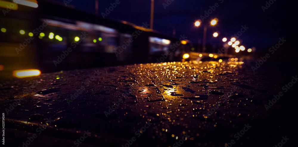 Night city, neon light, dark background, reflection of raindrops.