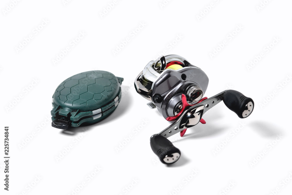 fishing reel and box for accessories on a white background, close-up fishing reel and box for accessories on a white background, close-up