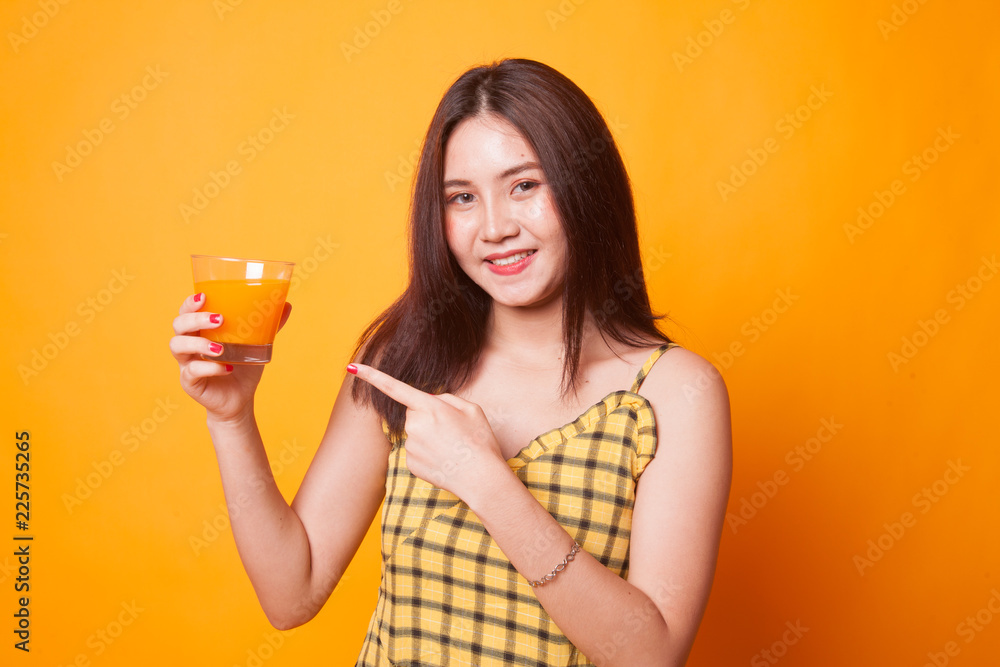 Young Asian woman point to orange juice. Young Asian woman point to orange juice.