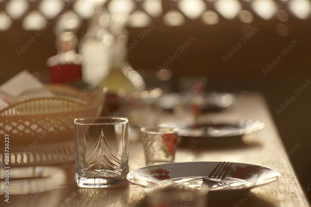 Glasses and plates on table - food background 