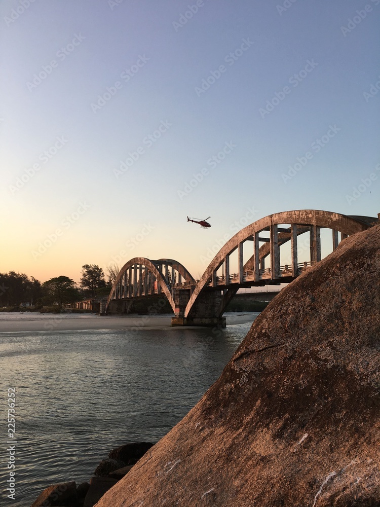 Fototapeta premium Helicopter above a brigde