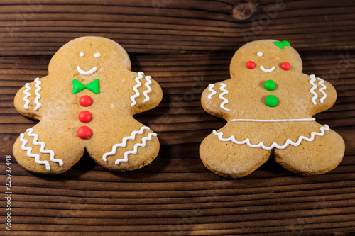 Christmas gingerbread couple cookies on wooden table