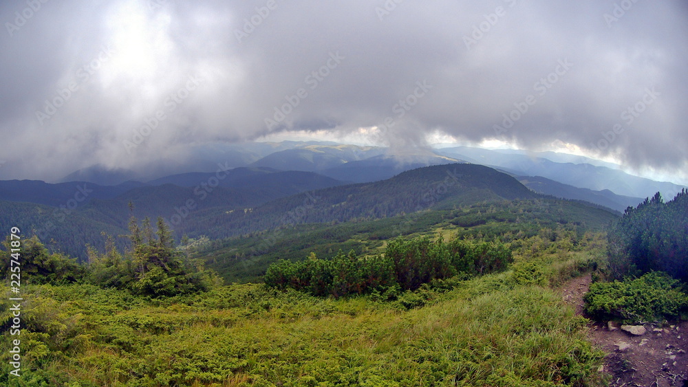 Fototapeta premium Clouds and fog over mountains