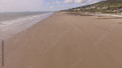 Aerial footage flying backwards over Barmouth beach.
