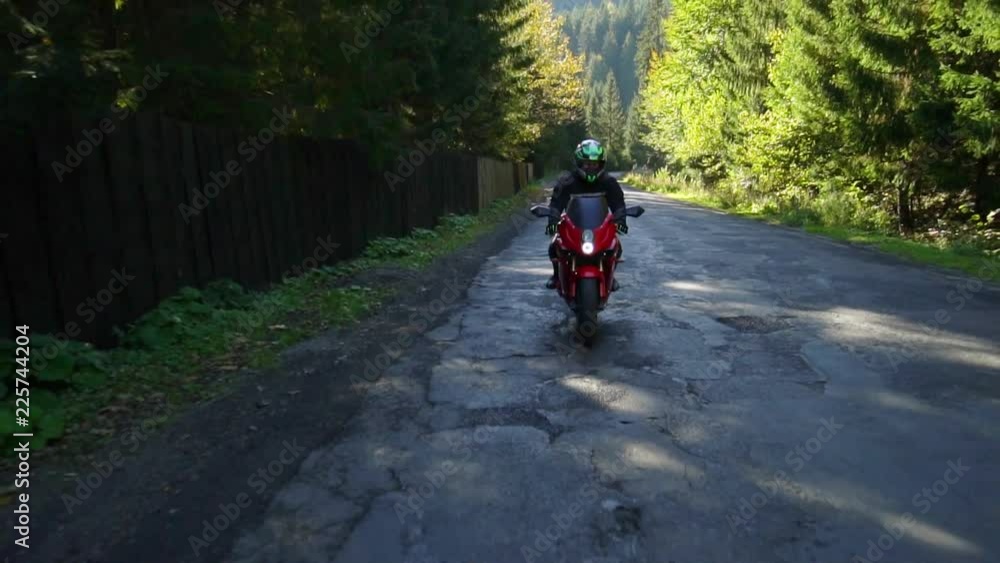 A guy on a motorcycle. Young handsome guy rides a motorcycle on a mountain road. A guy on a motorcycle. Young handsome guy rides a motorcycle on a mountain road.