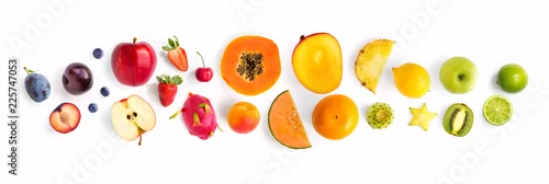 Obraz  z motywem Creative layout made of fruits. Flat lay. Plum, apple, strawberry, blueberry, papaya, pineapple, lemon, orange, lime, kiwi, melon, apricot, pitaya and carambola on the white background.