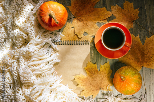 Autumn background with yellow maple leaves, black coffee and pumpkins. Layout for seasonal offers and holiday cards, top view. Golden October. SALE BLACK FRIDAY. Selective focus.