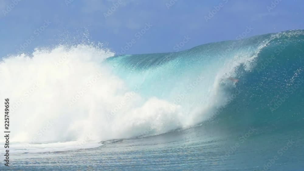 Loop of SLOW MOTION: Extreme pro surfer surfing big tube barrel wave Loop of SLOW MOTION: Extreme pro surfer surfing big tube barrel wave