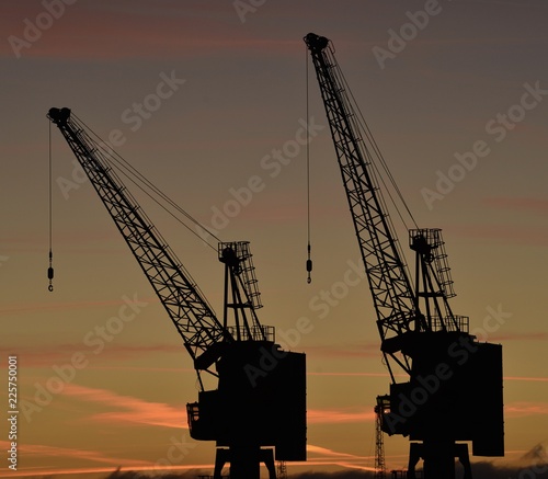Industrial sunset, Jersey, U.K. Cranes in silhouette.