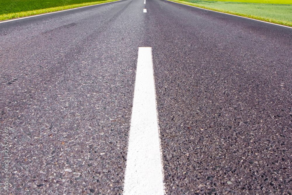 road marking on grey asphalt bitumen road background.