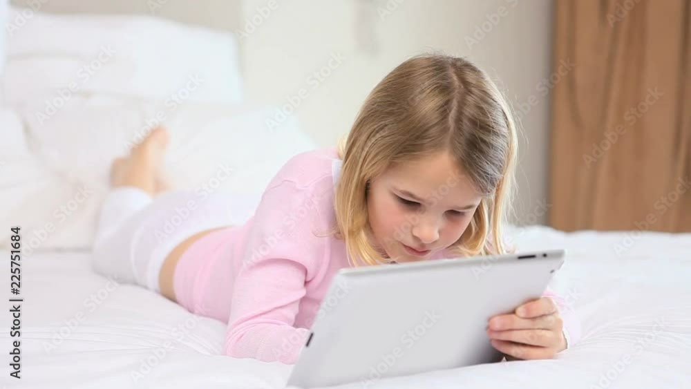 Loop of Blonde girl using a tablet computer Loop of Blonde girl using a tablet computer