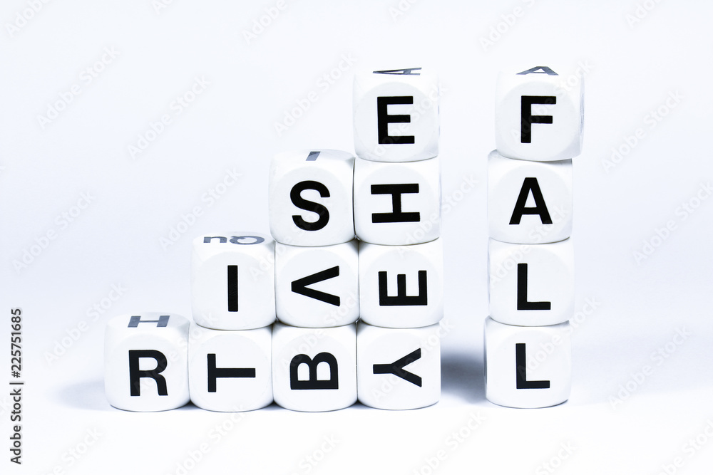 Lettered dice spelling out the words rise and fall on a white background Lettered dice spelling out the words rise and fall on a white background