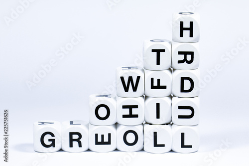 Lettered dice spelling out the word growth on a white background