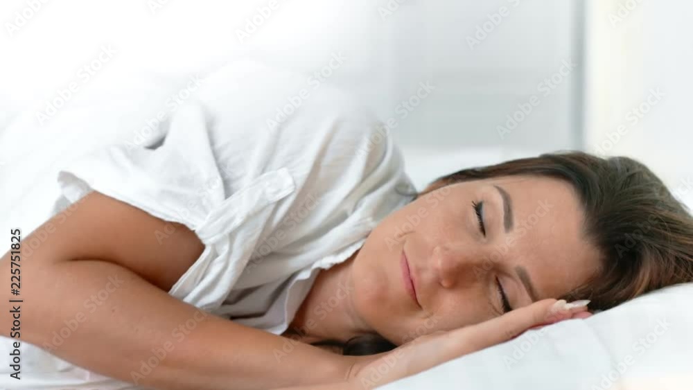 Portrait fresh smiling woman waking up at morning in cozy white bed at home Portrait fresh smiling woman waking up at morning in cozy white bed at home