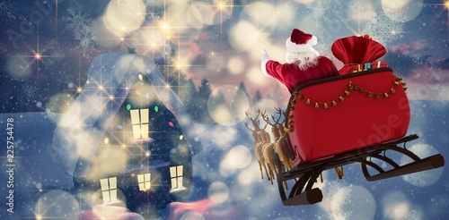 Obraz na płótnie Composite image of santa claus riding on sled with gift box