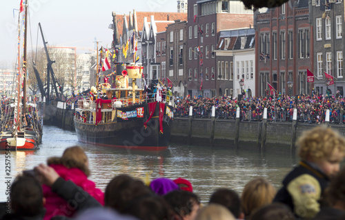 Ship of Saint Nicolas entering  the harbour of historical Dordrecht while the children wait in excited anticipation